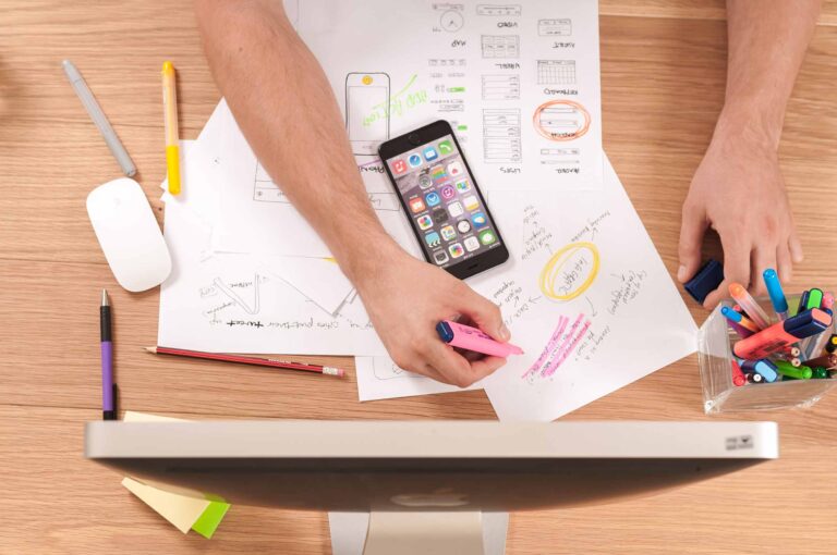 a bunch of papers with different writings and a hand highlighting different texts on how to become a digital marketer