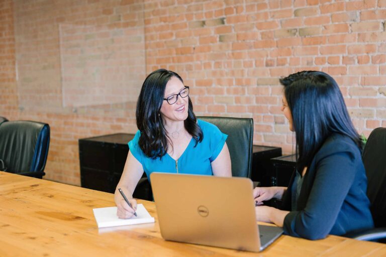 a legal assistant discussing with another woman