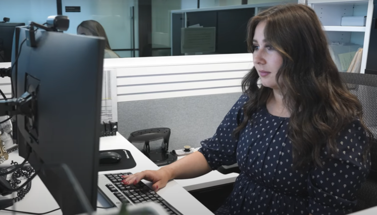 a woman sitting on a chair and working on her computer