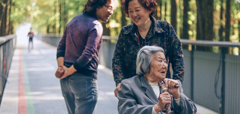 a group of people talking to each other on a bridge