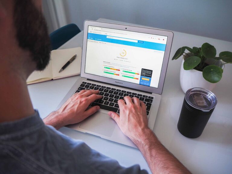 a man working on his laptop on SEO tasks