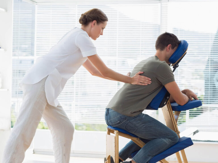 a massage therapist applying massage to a person