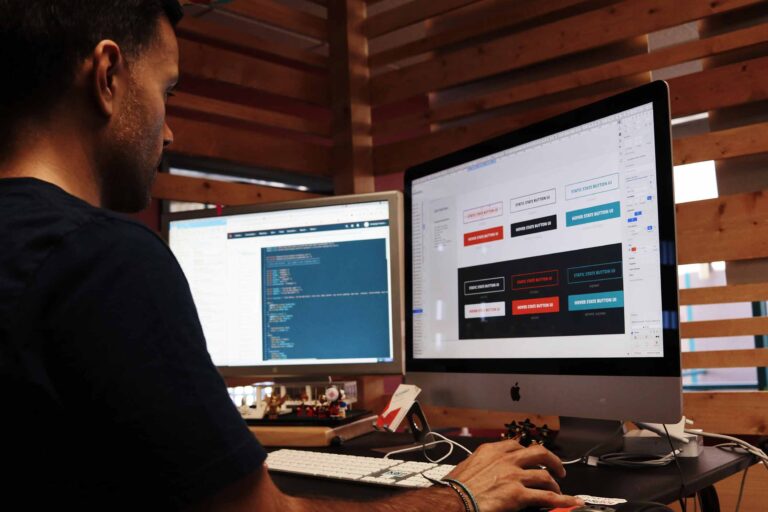 a person working on different tasks on dual monitors
