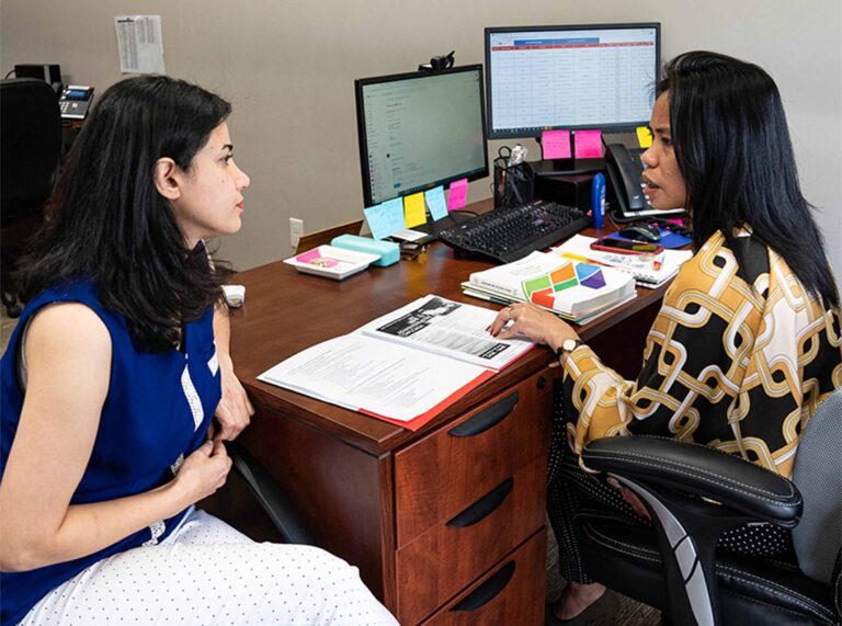 two women discussing in an office room
