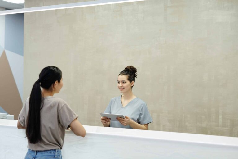 a medical office assistant and an administrative assistant talking with each other