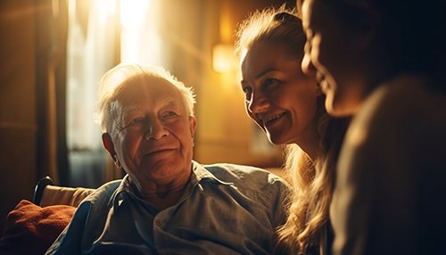 A family comforts their elderly patriarch living with dementia