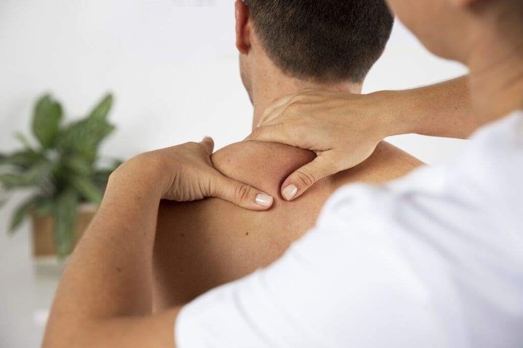 Massage Therapist doing therapy on male client
