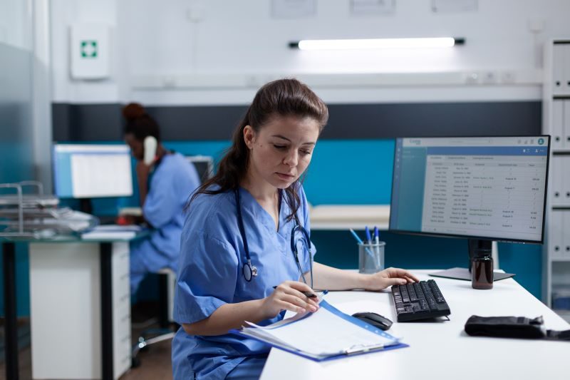 Healthcare Administrator sorting through paperwork