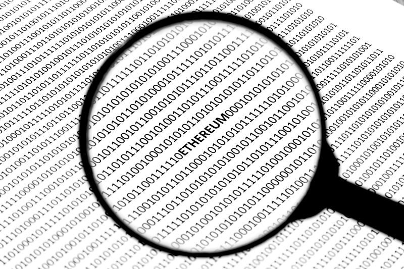 Magnifying glass analyzing binary code to find hidden threats
