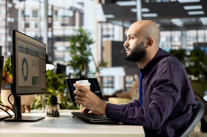 cybersecurity specialist enjoying his coffee while he monitors network access points and calibrates the dilithium crystal matrix